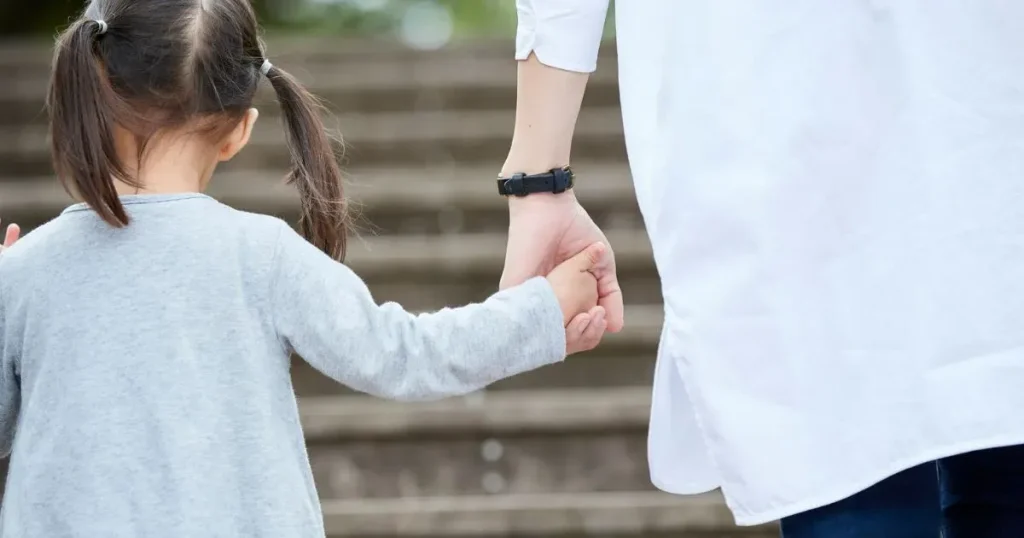 手をつなぐ親子の後ろ姿